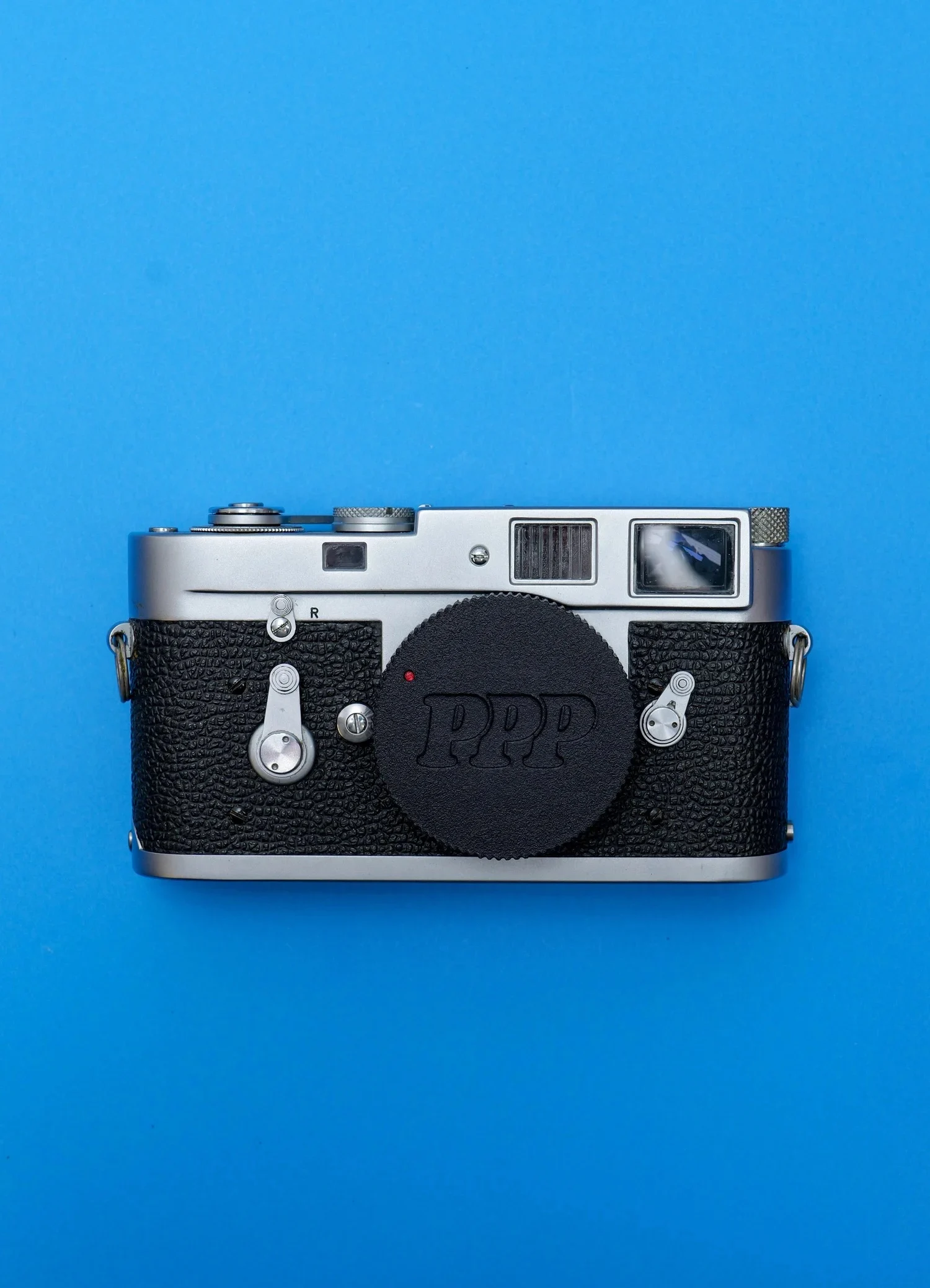 This Clever Leica Lens Cap Hides an AirTag Tracker in Plain Sight