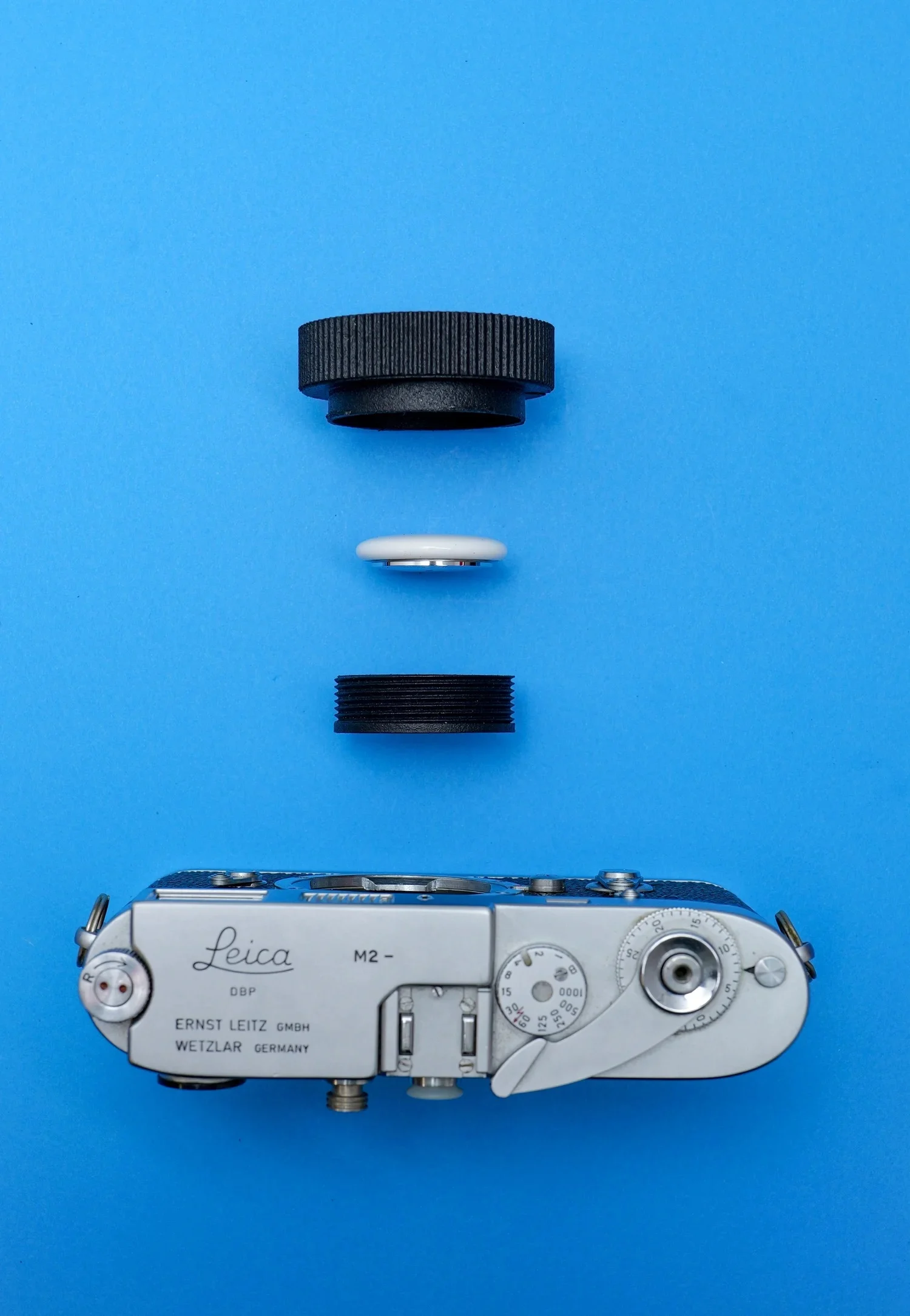 This Clever Leica Lens Cap Hides an AirTag Tracker in Plain Sight