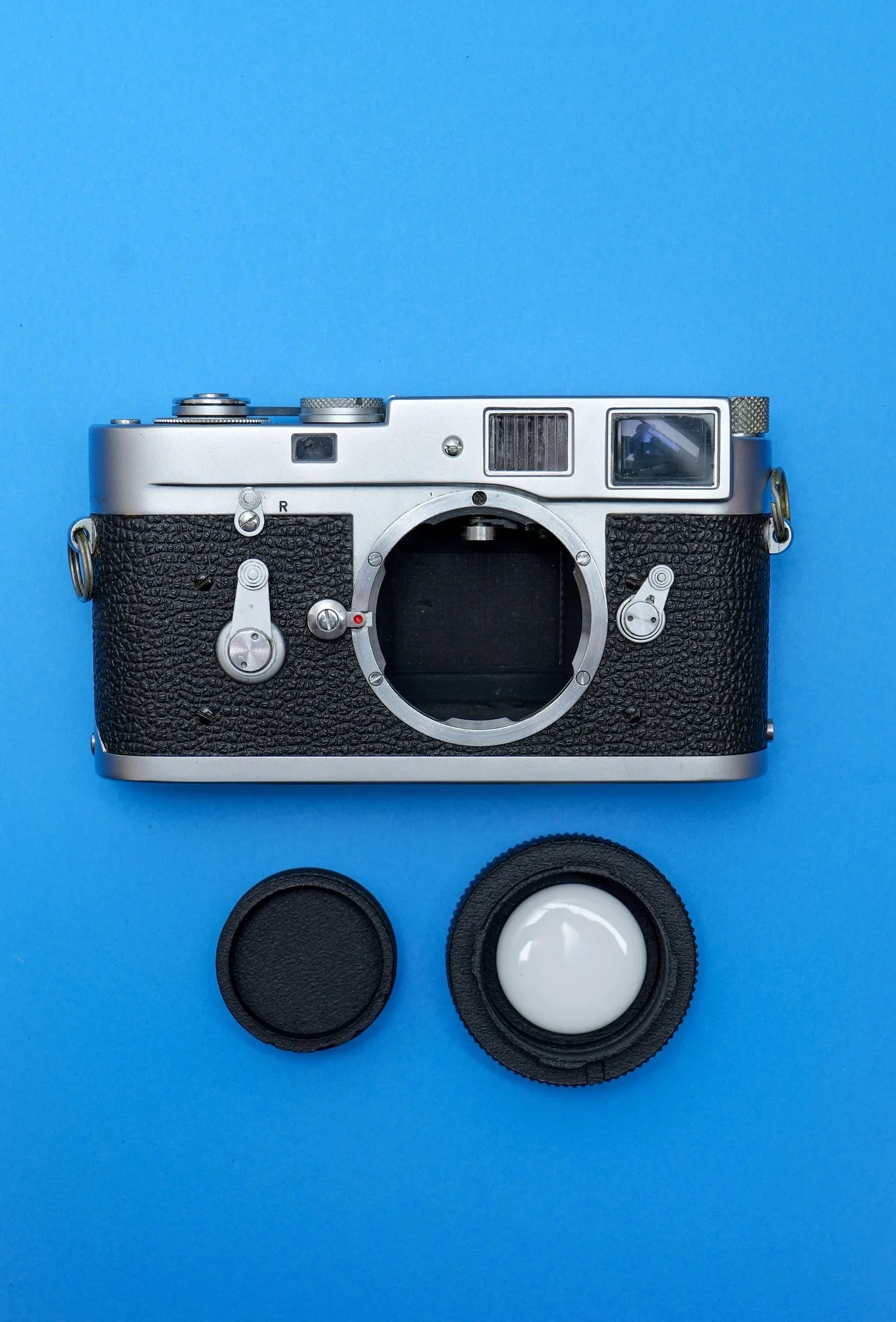 This Clever Leica Lens Cap Hides an AirTag Tracker in Plain Sight