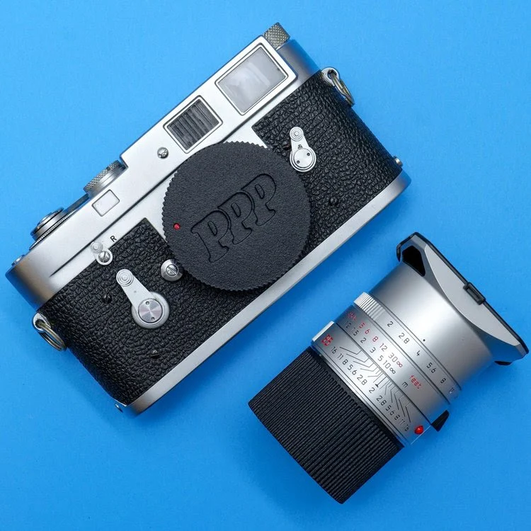 This Clever Leica Lens Cap Hides an AirTag Tracker in Plain Sight