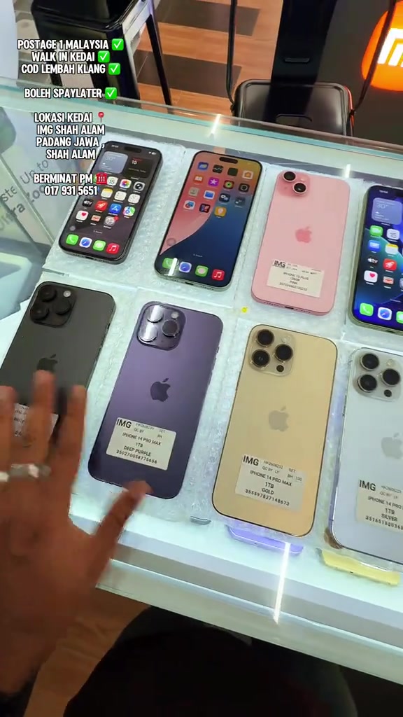 Pameran iPhone terpakai di kedai dengan teks overlay: postage 1 Malaysia, walk in kedai, COD Lembah Klang, boleh SPayLater dan lokasi kedai IMG Shah Alam Padang Jawa