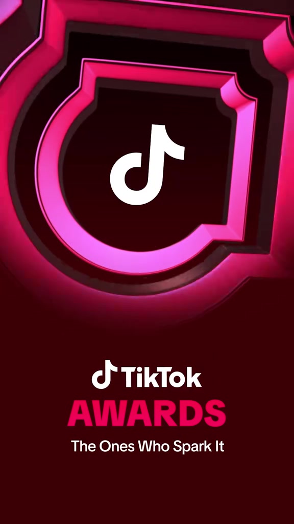 Logo TikTok Awards màu hồng tím nổi trên nền đỏ sẫm kèm khẩu hiệu The Ones Who Spark It