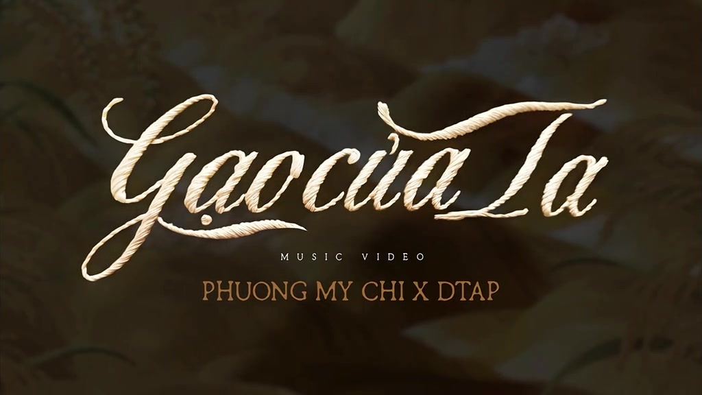Thẻ tiêu đề MV Gạo của Ta: chữ viết tay màu kem trên nền hạt lúa, kèm dòng Music Video và Phuong My Chi x DTAP
