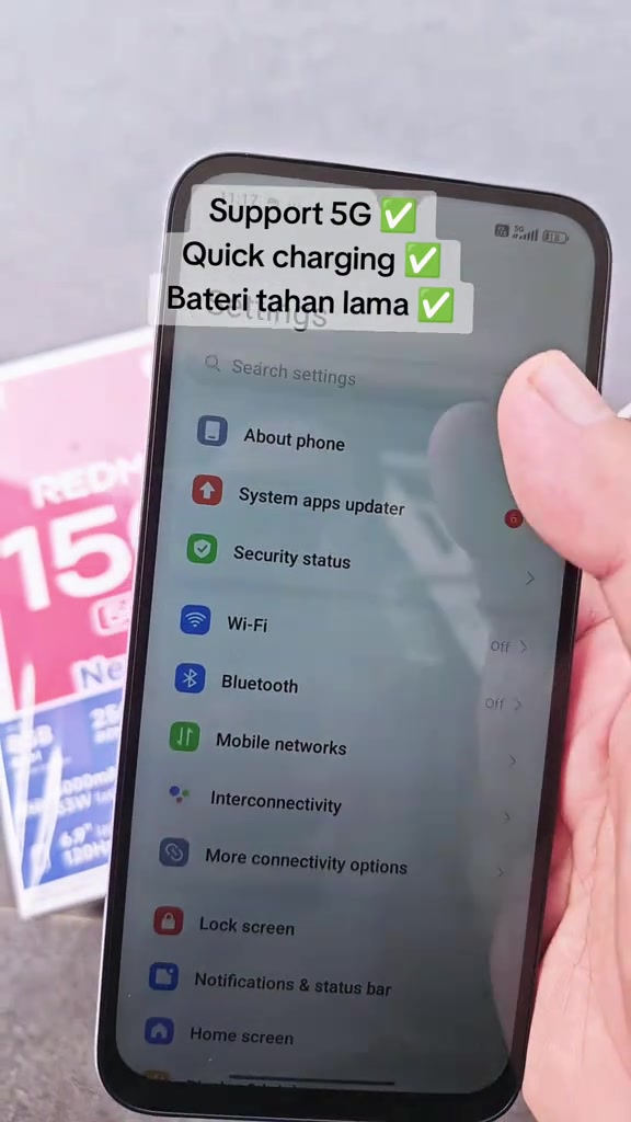Skrin tetapan telefon Redmi dengan kotak REDMI 15C di belakang dan overlay menyebut sokongan 5G, pengecasan pantas serta bateri tahan lama