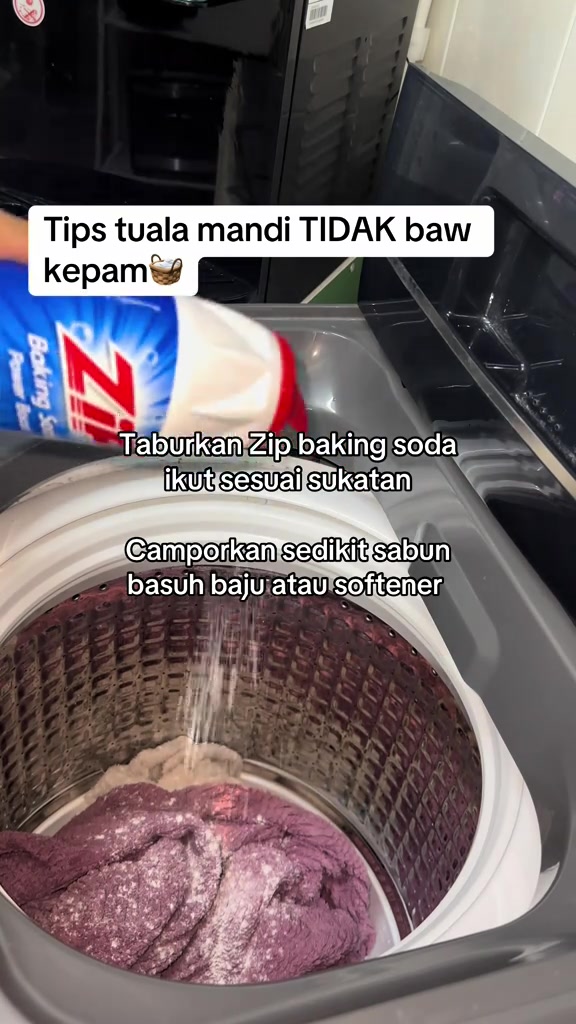 Baking soda ditabur ke dalam mesin basuh top load yang berisi tuala