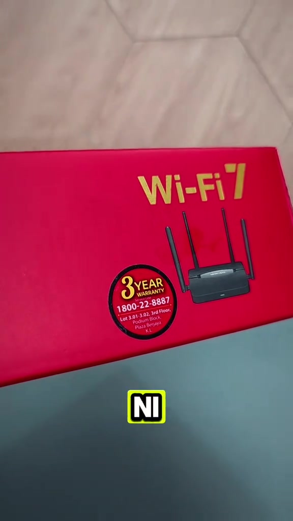 Kotak merah Mercusys Wi-Fi 7 dengan pelekat waranti 3 tahun dan nombor hotline 1800-22-8887