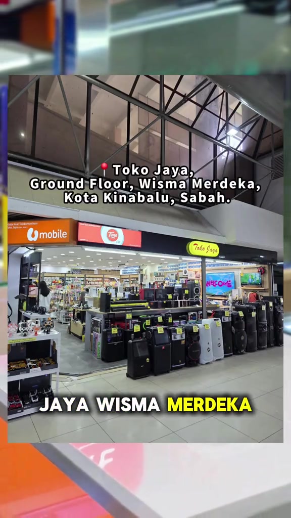 Kedai Toko Jaya di Ground Floor, Wisma Merdeka, Kota Kinabalu, dengan deretan peti sejuk dan peralatan elektrik di hadapan kaunter Unifi Mobile