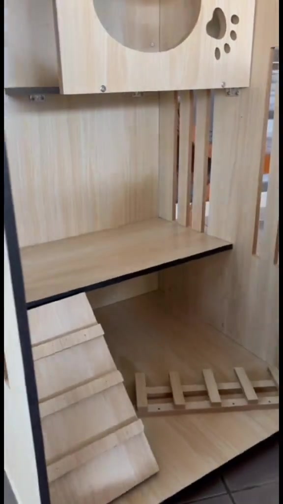 Bahagian dalam sangkar kayu dengan platform, tanjakan bertingkat dan tangga kayu, tiada kucing di dalam