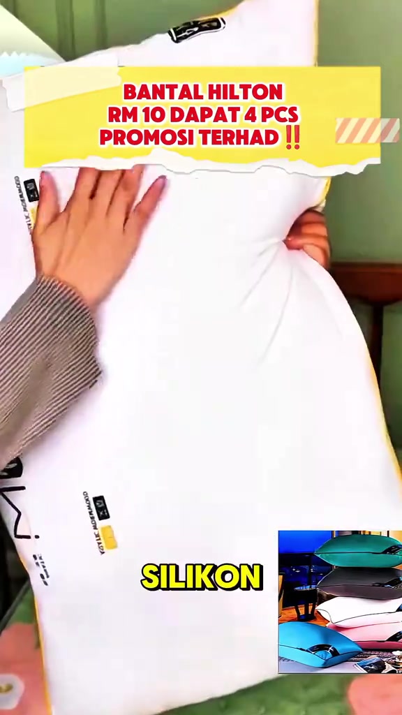 Tangan menekan bantal putih besar yang lembut dengan kapsyen SILIKON