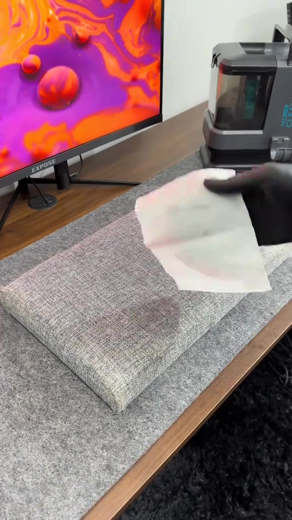 Tangan menekan tisu putih atas kusyen sofa selepas cuci untuk test sama ada sudah kering